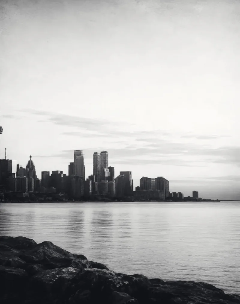 Toronto skyline at dusk across the harbour